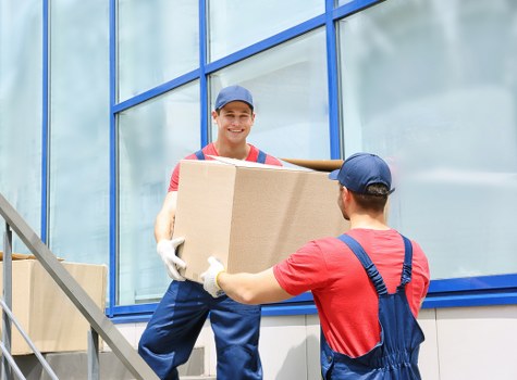 Man with a van loading furniture for a local move in Enfield
