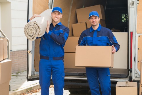 Removal team preparing flat furniture for a move in Enfield